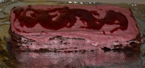 I call this the Adult Cake. It is a chocolate souffle cake (flour free) with whipped cream mixed with raspberry syrup then drizzled with raspberry jam thinned out with raspberry syrup. 